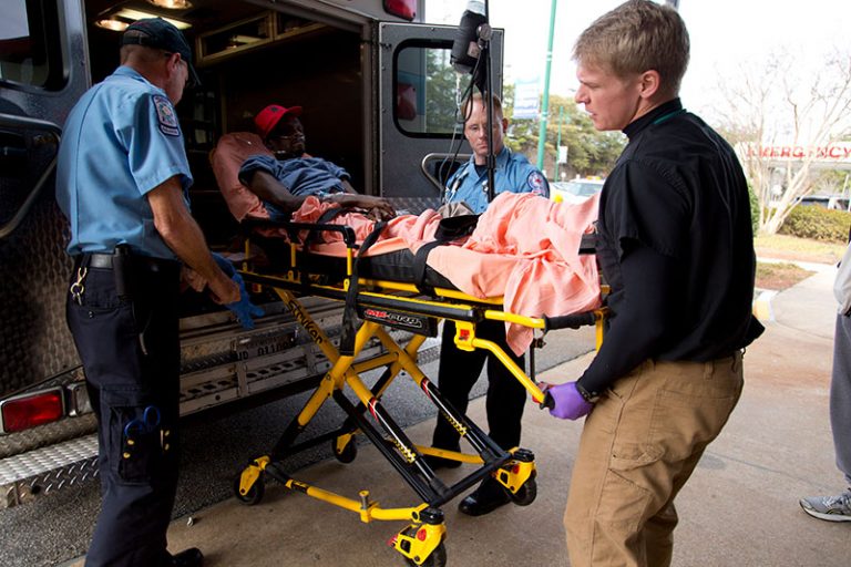 A woman being put on a stretcher
